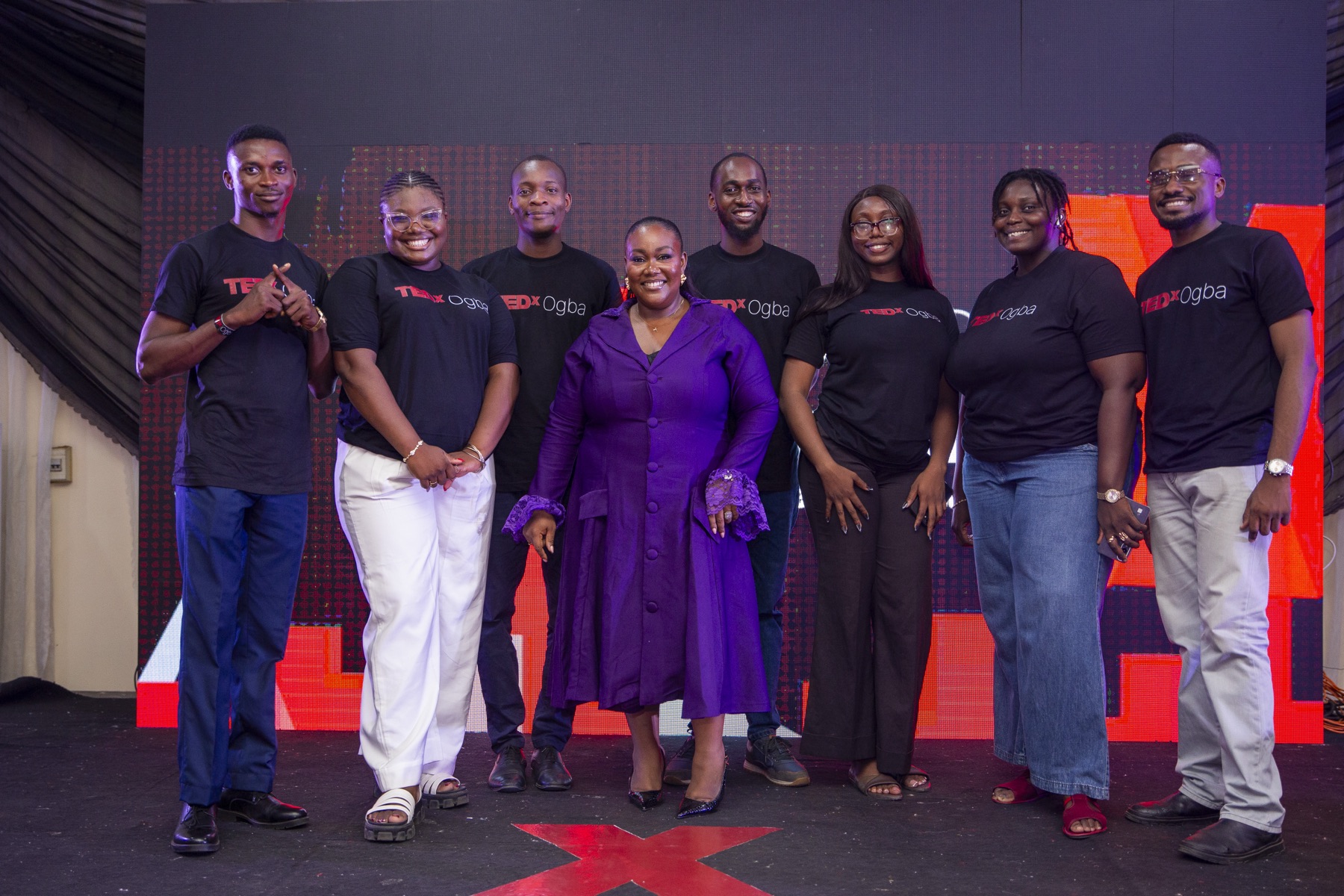 The TEDxOgba organizing team on stage, with Vanessa front and center